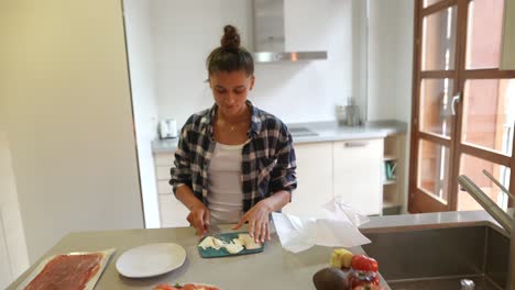 woman preparing a sandwich in a kitchen