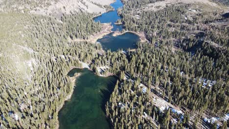 drone tilting over alpine lakes and forest in mammoth lakes