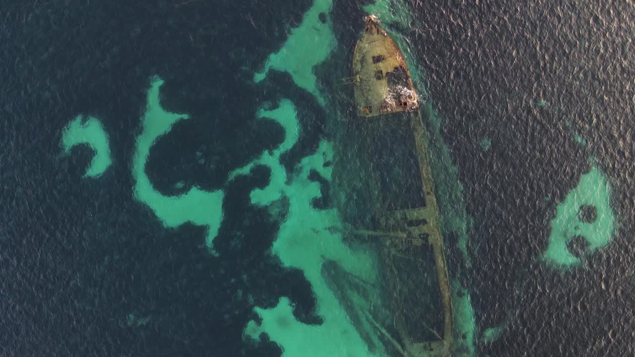 Aerial View of a Shipwreck in Clear Turquoise Waters