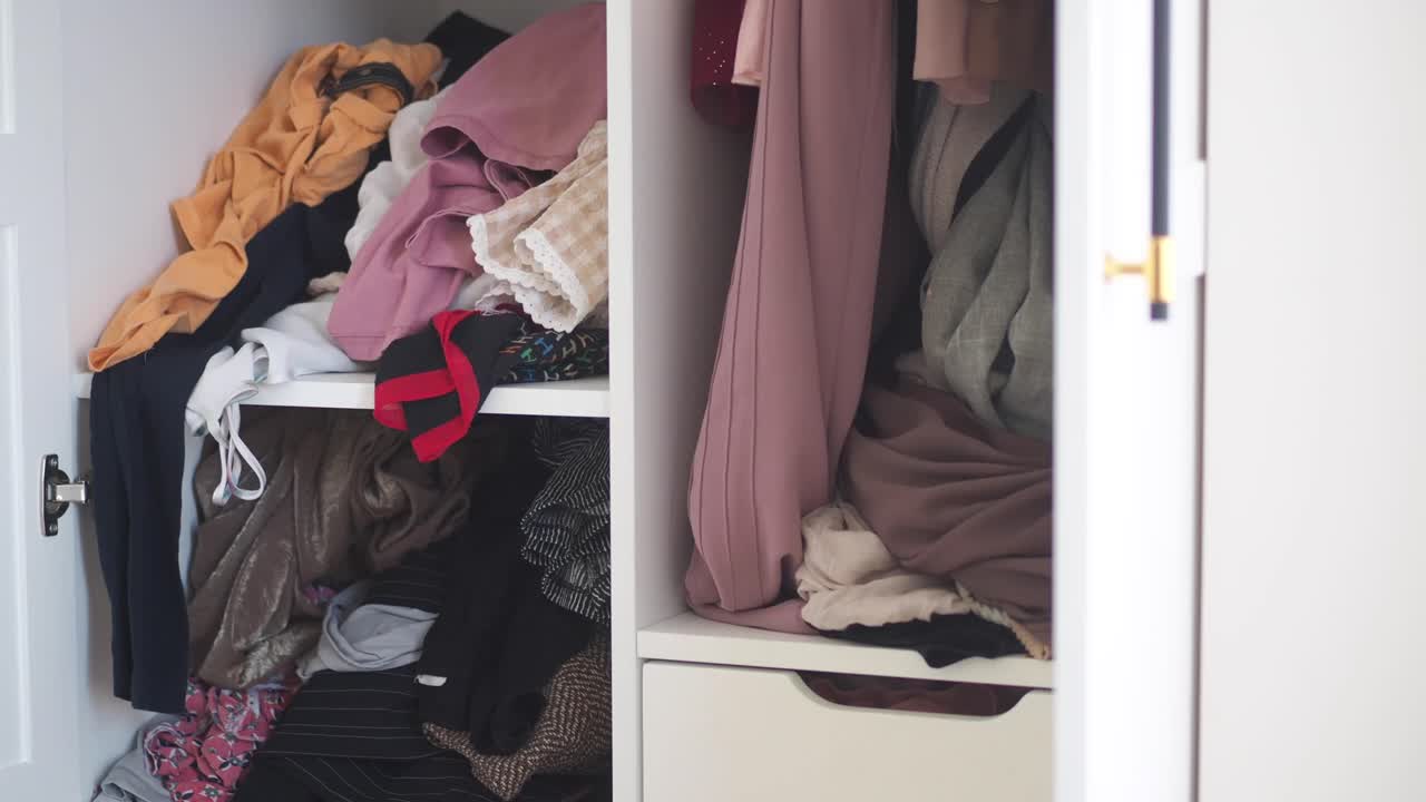 Messy Wardrobe Full of Clothes