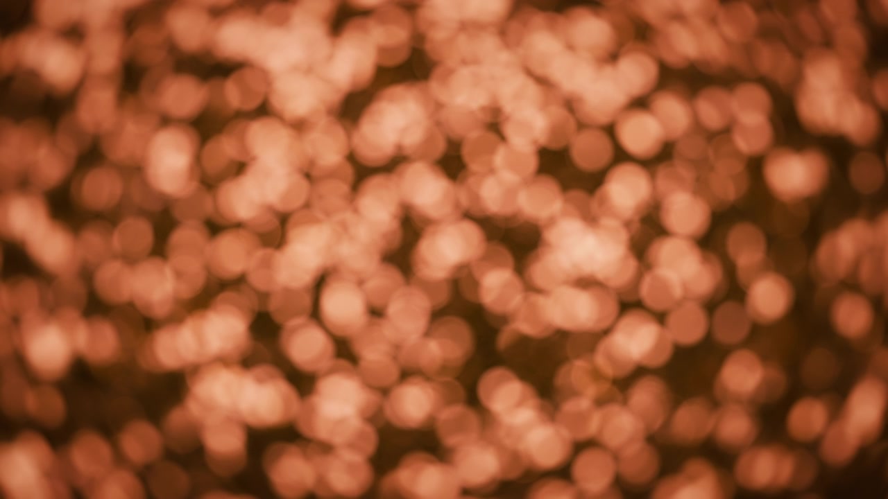 Sfondo bokeh astratto di glitter color bronzo luminoso
