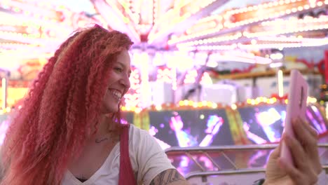 happy woman with red hair taking a selfie at the fair