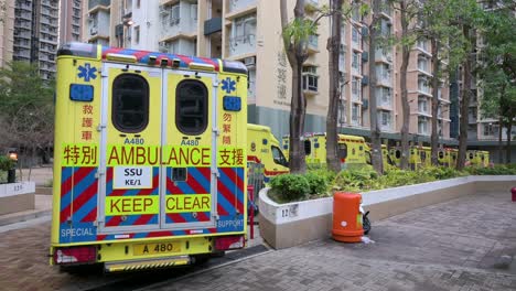 a row of ambulances are seen parked outside a building placed under covid-19 coronavirus lockdown at a public housing complex after a large number of residents tested positive