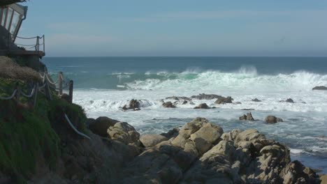 Waves-crashing-on-Carmel-Beach-with-house-on