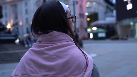 pretty girl exploring downtown london alone at dusk