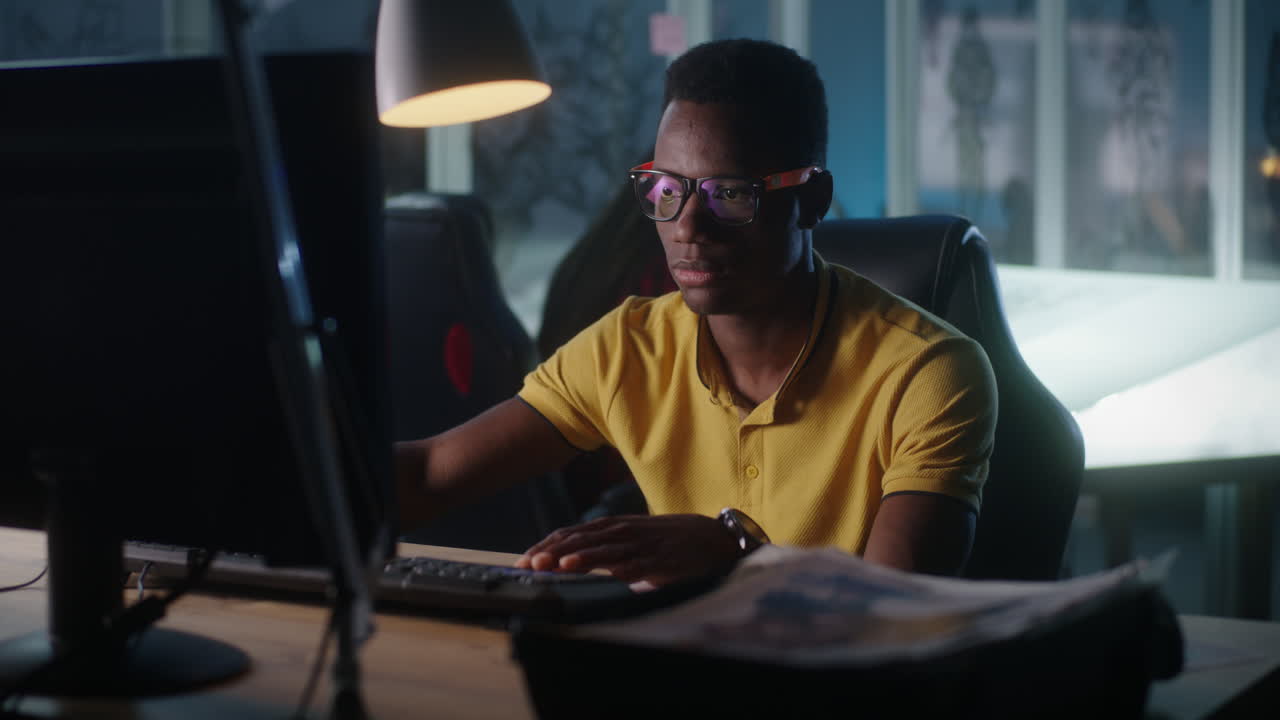 Young Man Working on Computer at Night