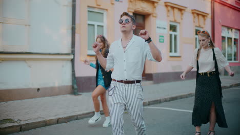 young people dancing on city street