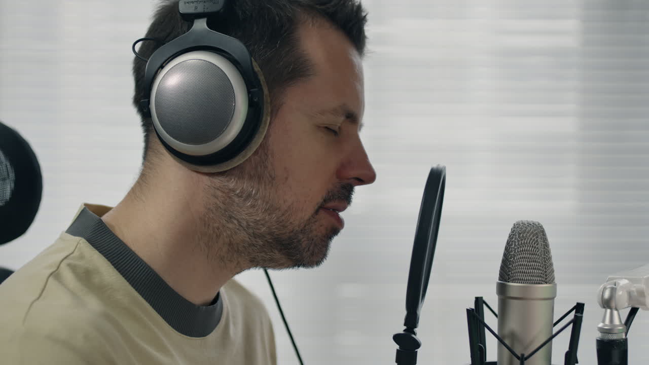 Man Singing Into Microphone in Home Recording Studio