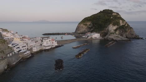 Scenic-peninsula-Italian-city-Sant’Angelo,-sunset-aerial-forward-to-sand-beach