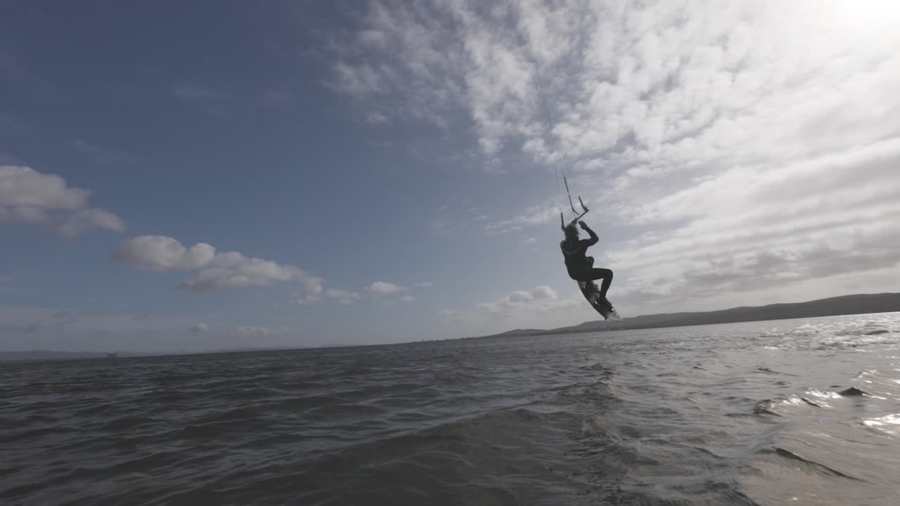 Windsurfer surfing across the ocean tide -slowmo