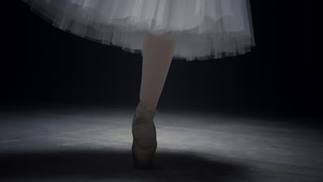 Ballerina-legs-dancing-on-tiptoe.-Ballet-dancer-feet-performing-in-pointe-shoes.