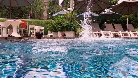 person swimming and splashing in a pool