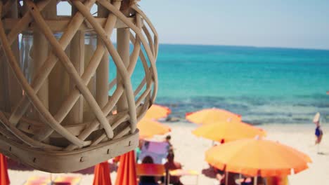 Candle-swings-in-front-of-beautiful-beach---slow-motion