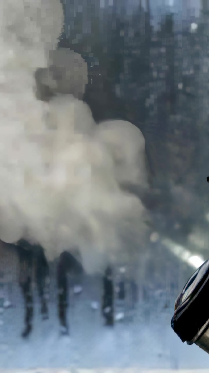 Vertical video: Emitting puff from vaporizer nozzle, dense cloud expanding near streaked window