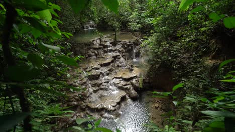 small waterfalls surrounded by greenery in the chiapas rainforest of mexico