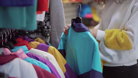 woman shopping for jackets in a clothing store