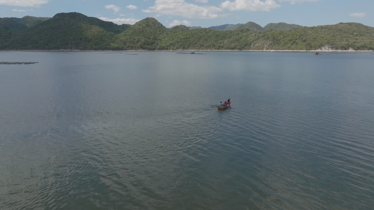 Person rowing on boat on lake of Hatillo dam, Dominican Republic