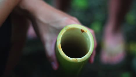 campers preparing food and meat in the jungle using bamboo shoot to steam the raw meat