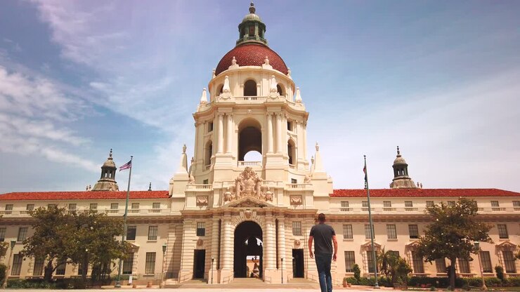 Uomo che cammina verso il Municipio di Pasadena, ripresa dal basso, in stile mediterraneo e neomoresco spagnolo, California.