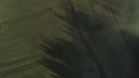 Above-Poland-countryside-during-dawn-with-light-mist,-top-down-aerial