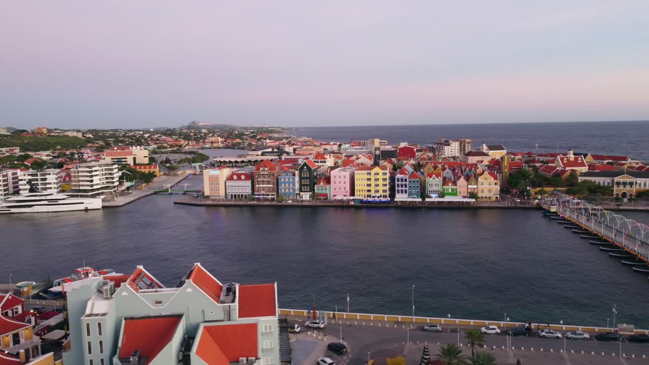 Aerial Pan of St. Anna Bay, Queen Emma Bridge and Colorful UNESCO Buildings on Handelskade Street in Punda Willemstad Curacao