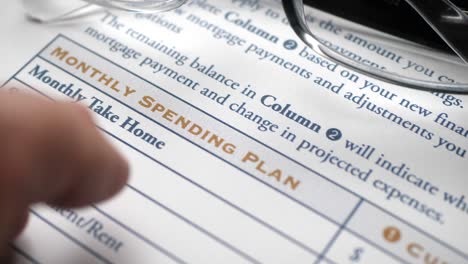 finger tapping on monthly spending plan