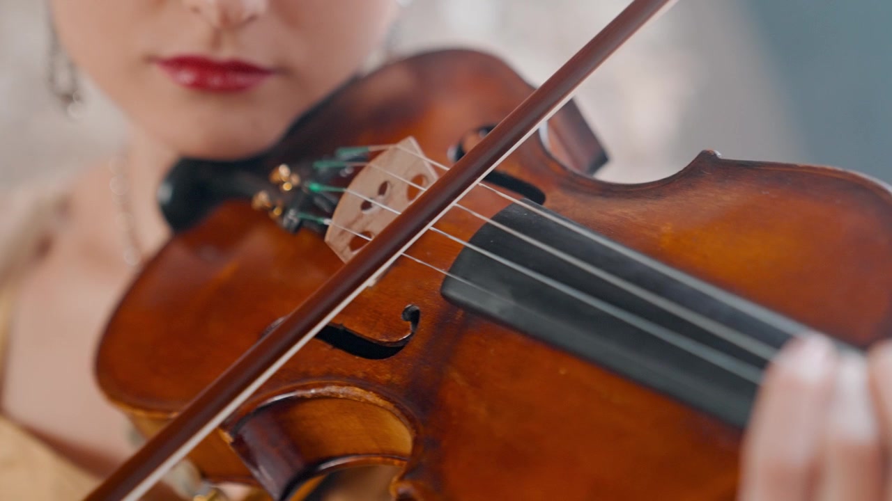 Close-up of a Woman Playing the Violin with a Bow