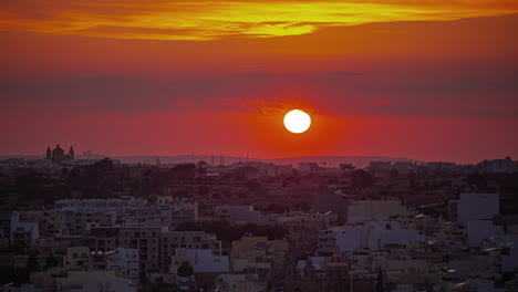 sunset over the maltese village of marsaxlokk - telephoto time lapse