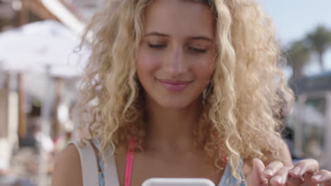 portrait of happy beautiful blonde woman using smartphone