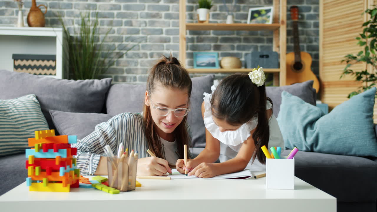 어머니와 딸이 함께 그림을 그리고 있습니다.