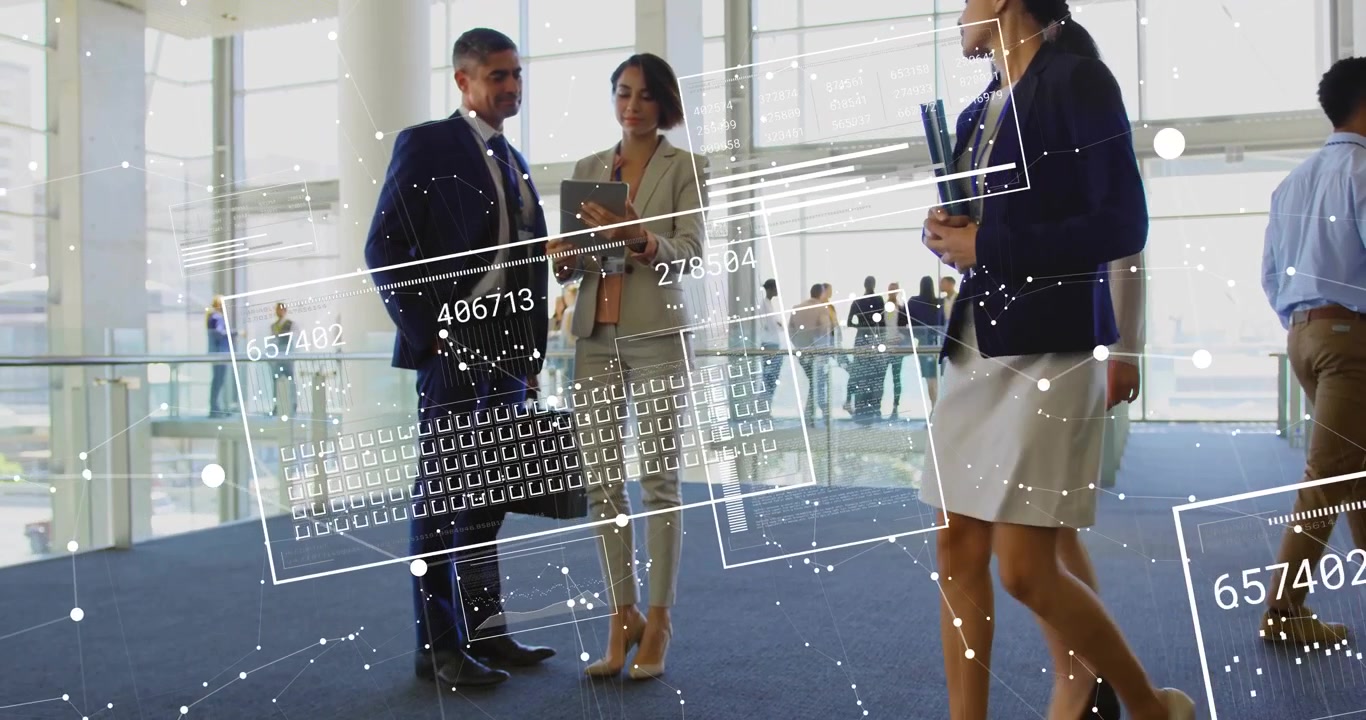 Woman pointing tablet screen activating analytics overlay as business team walking past atrium