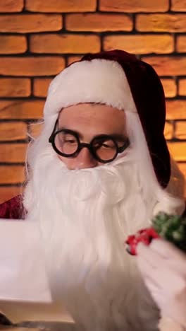 a cheerful santa reads childrens letters in a heartwarming video a jovial man in a santa suit brings holiday joy reading childrens letters by a brick wall his warmth captures christmas magic for all