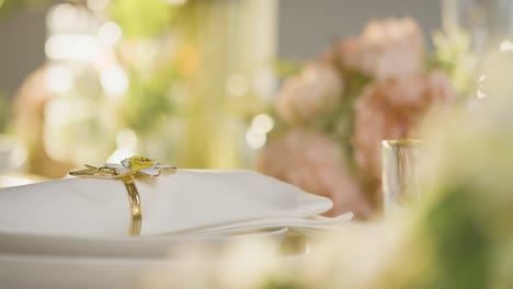 Close-Up-Of-Napkin-In-Ring-On-Table-Set-For-Meal-At-Wedding-Reception-In-Restaurant