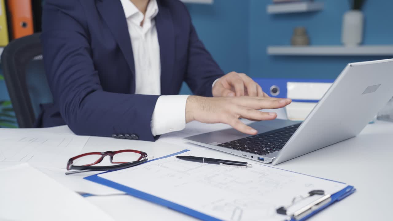 Office worker man's hands hurt from working hard.