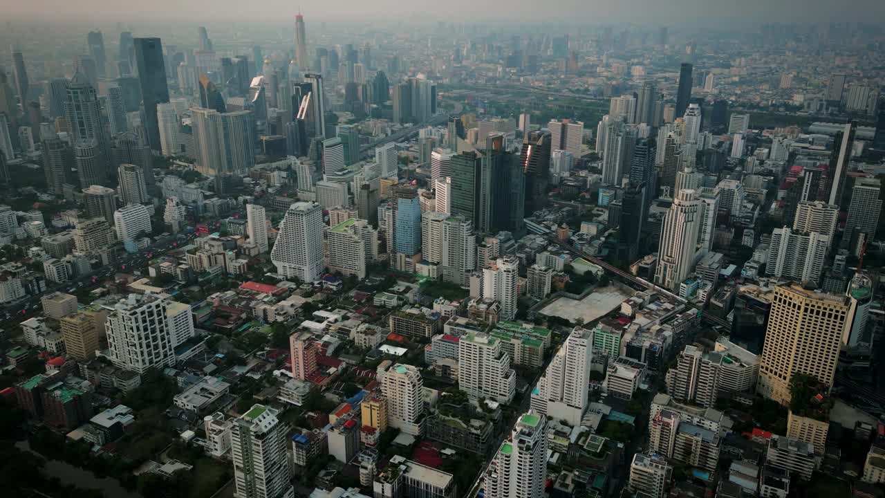 Aerial Scenic Drone Footage of the Skyline of Downtown Bangkok, Thailand Covered in Smog during Sunset during the Smokey Burning Season