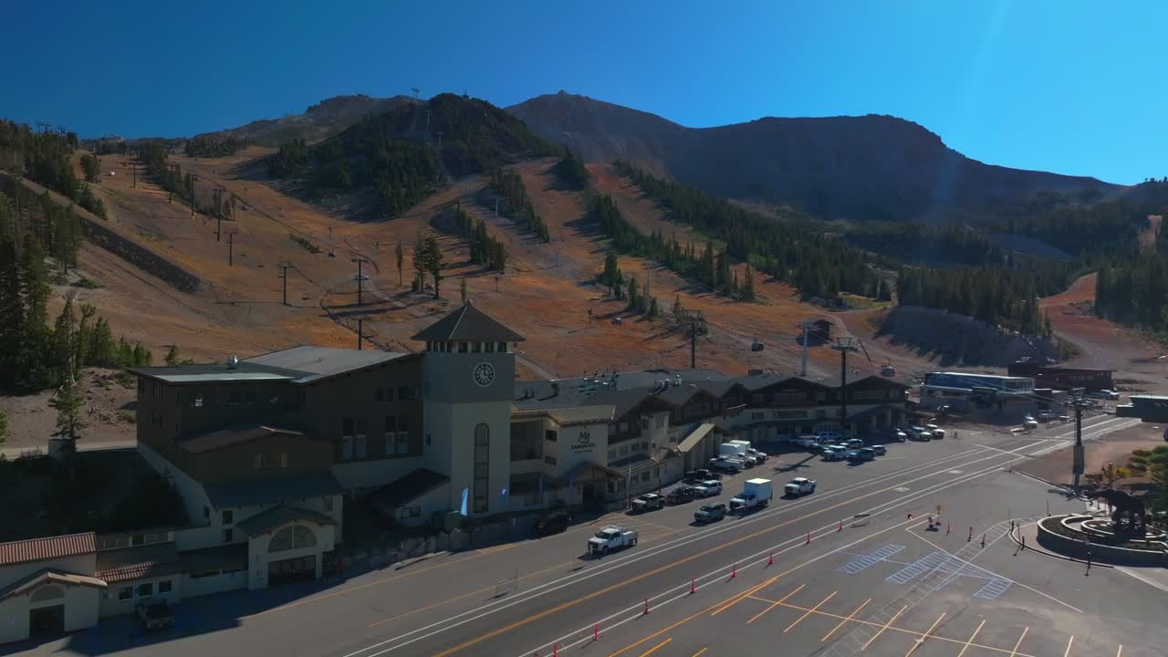 Mammoth Lakes Mountain Ski Area McCoy Station Main lodge Minarets Upper Panorama Gondola summer autumn fall aerial drone California parking lot cars sunny daytime blue sky chairlift gondola upwards