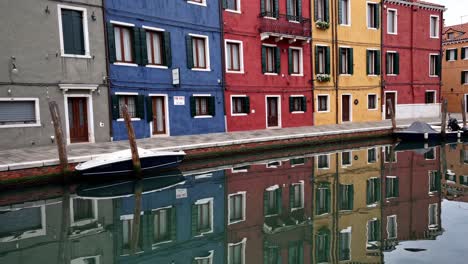 colorful houses and reflections on a venetian canal