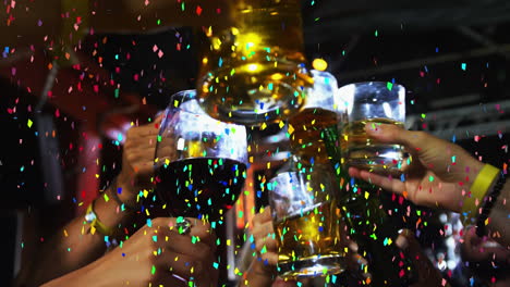 animation of multi coloured confetti falling over people making toast
