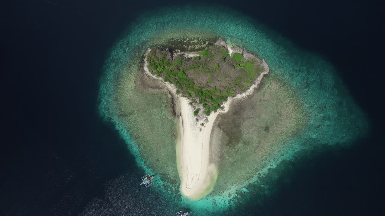 Rising top down drone shot of an isolated island in the Philippines.