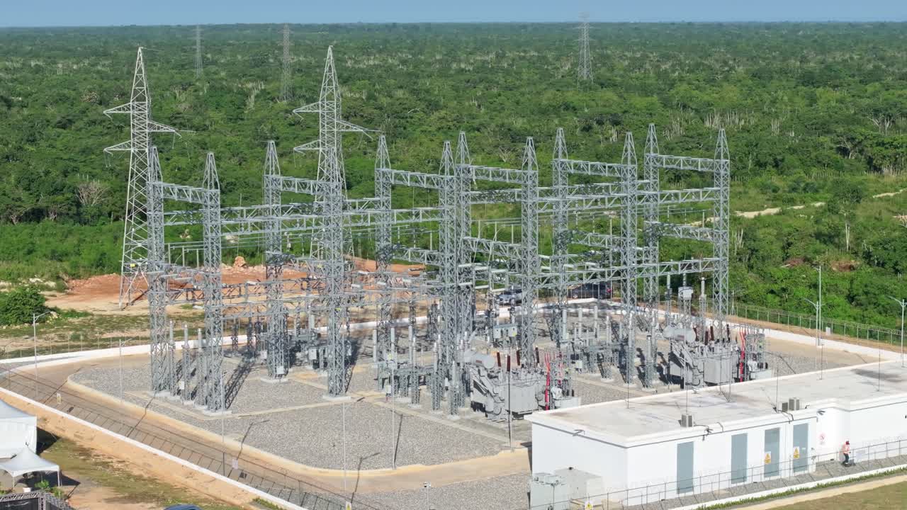 Drone orbit shot of electrical substation supply solar panels in scenic area of Dominican Republic - Electric power plant park