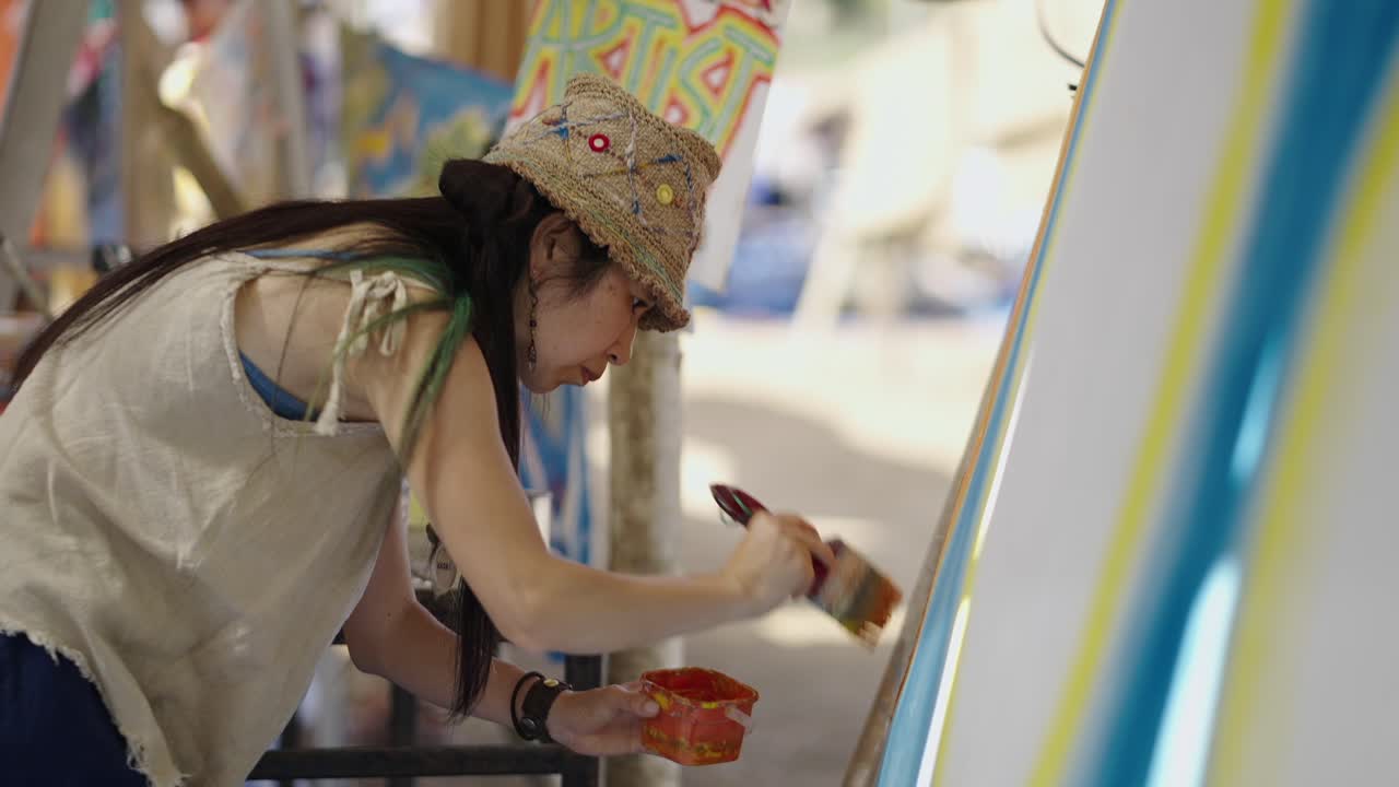 Artist painting on an easel in an outdoor art setting