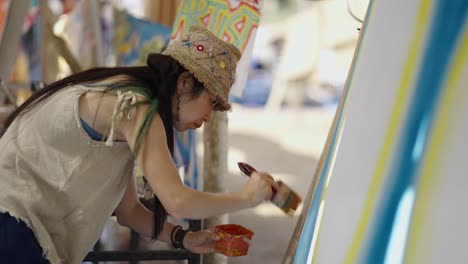 artist painting on an easel in an outdoor art setting