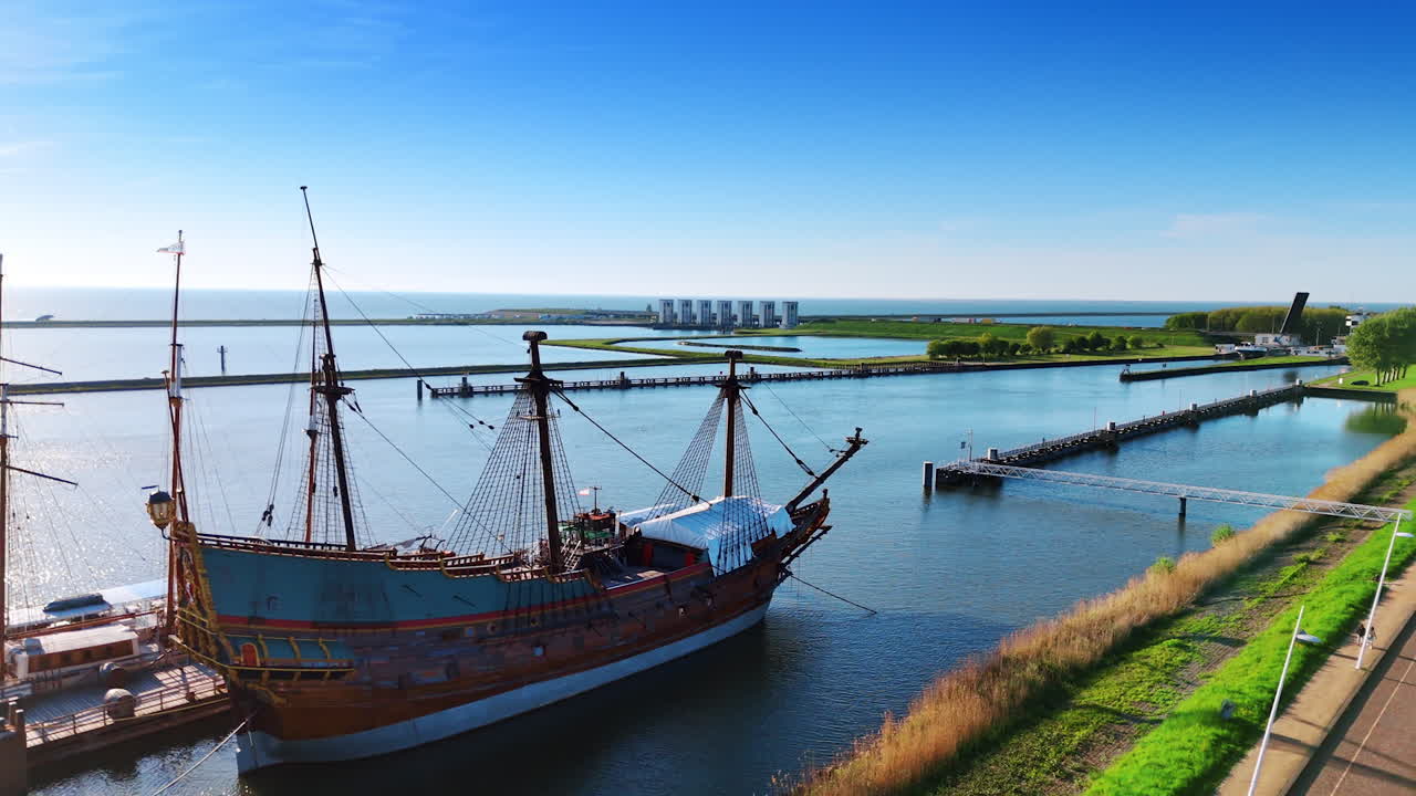 Approaching beautiful reconstruction of a 17-century ship Batavia. Lake Markemeer, Historical Museum Batavialand in Lelystad, the Netherlands.