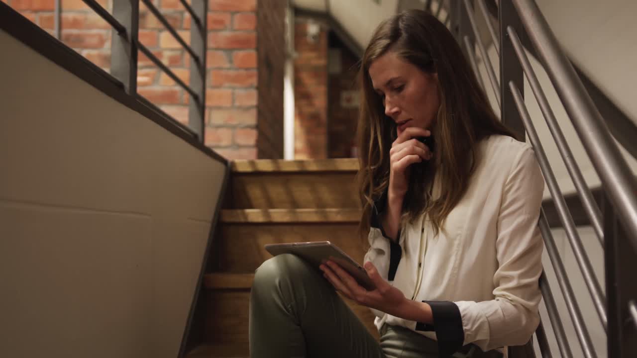 Creative businesswoman using digital table in modern office
