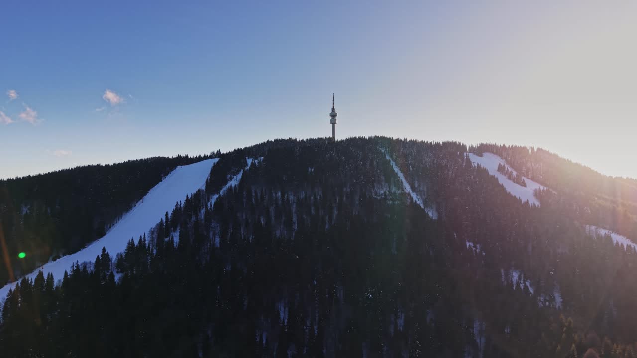 Mountains in Carpathians show snow-covered slopes and tower in Bulgaria