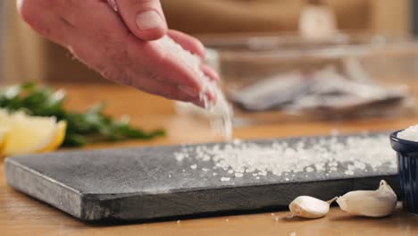 seasoning fish with salt