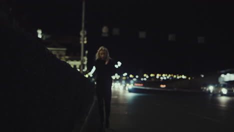 Woman-walking-city-night-on-highway-alone-in-urban-area-street.