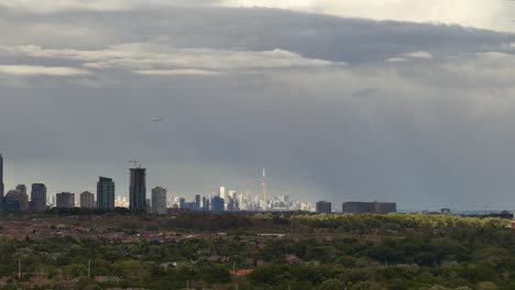 shifting clouds letting the sun cast beautiful rays over mississauga and toronto skyline