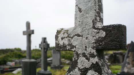 Old-Tombstone-in-Shape-of-a-Cross-on-a-Cloudy-Day-in-a-Cemetery-Close-Up