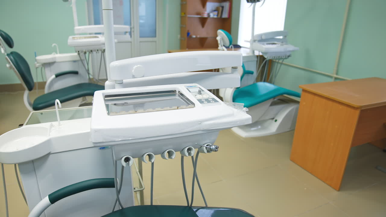 Educational models of dentistry armchairs in the medical school classroom. Stomatology chairs alongside with usual desks and chairs.
